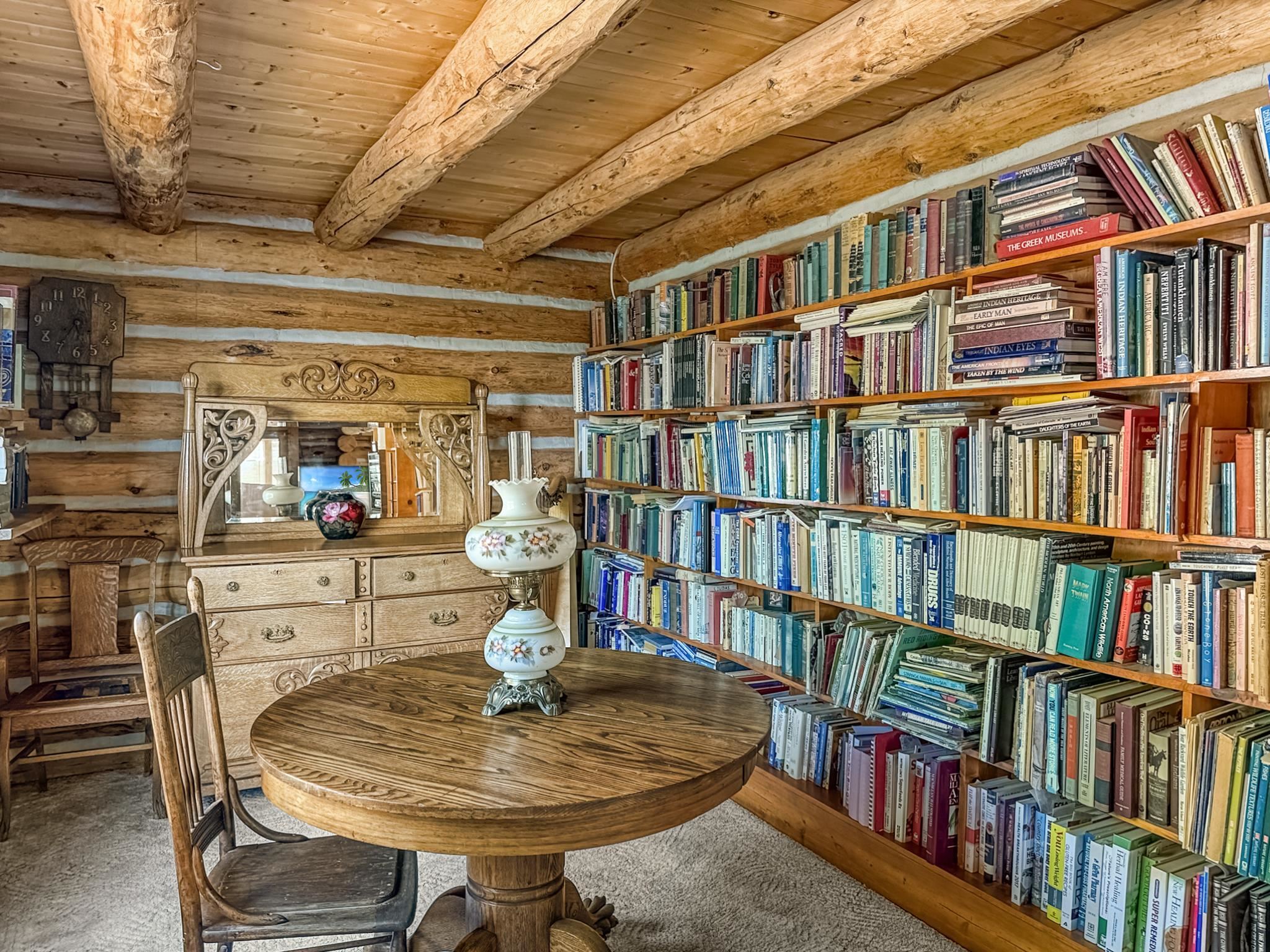 9709 3605 Road Hotchkiss, CO 81419 - Photo 16 of 42 a dining room with lots of furniture and a book shelf