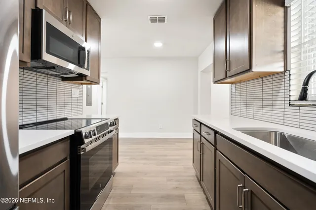 a kitchen that has a sink and a stove