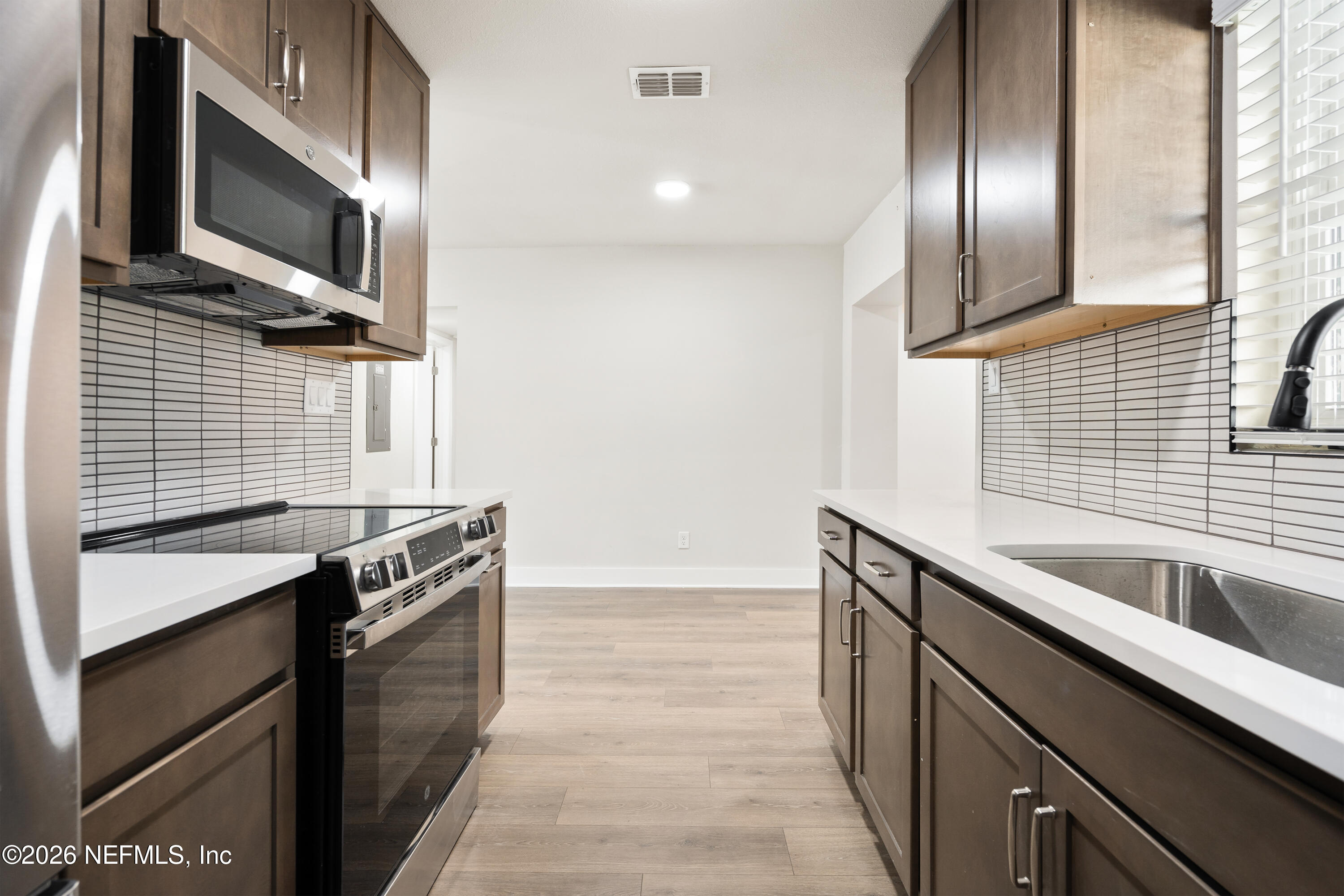 1241 Hibiscus Street St. Augustine, FL 32084 - Photo 11 of 27 a kitchen that has a sink and a stove