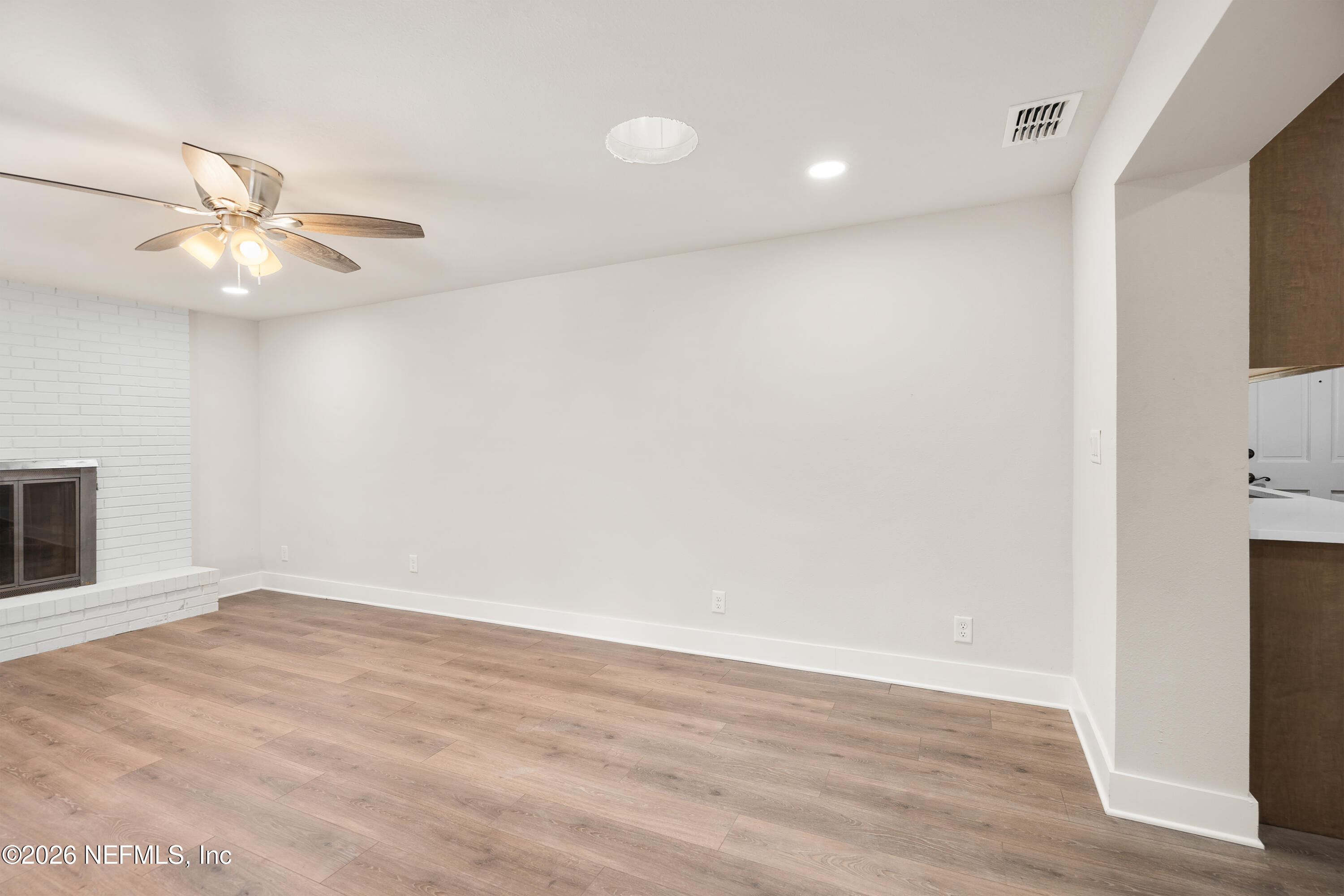 1241 Hibiscus Street St. Augustine, FL 32084 - Photo 14 of 27 an empty room with wooden floor fan and windows