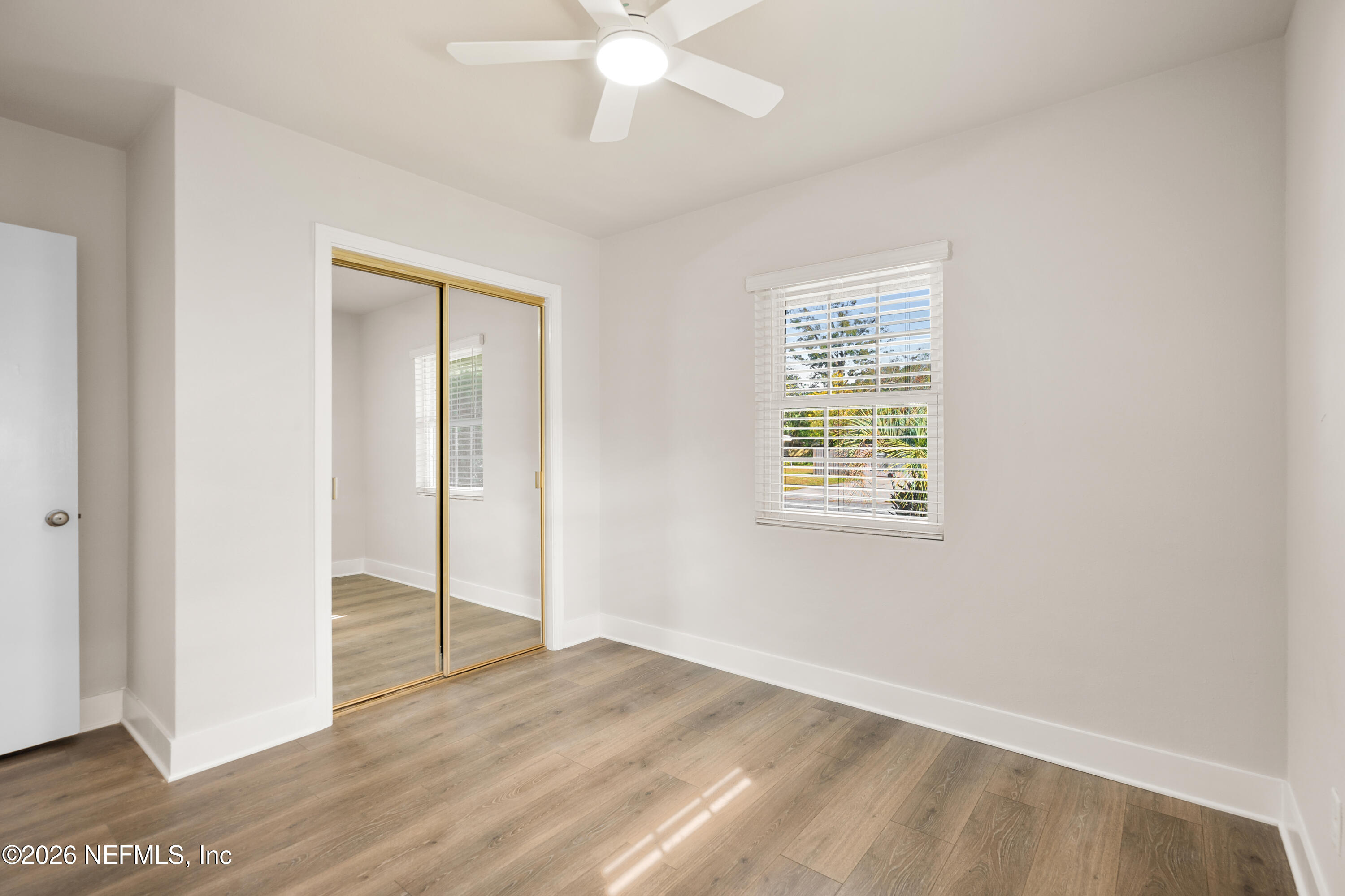 1241 Hibiscus Street St. Augustine, FL 32084 - Photo 16 of 27 a view of an empty room with wooden floor and a window