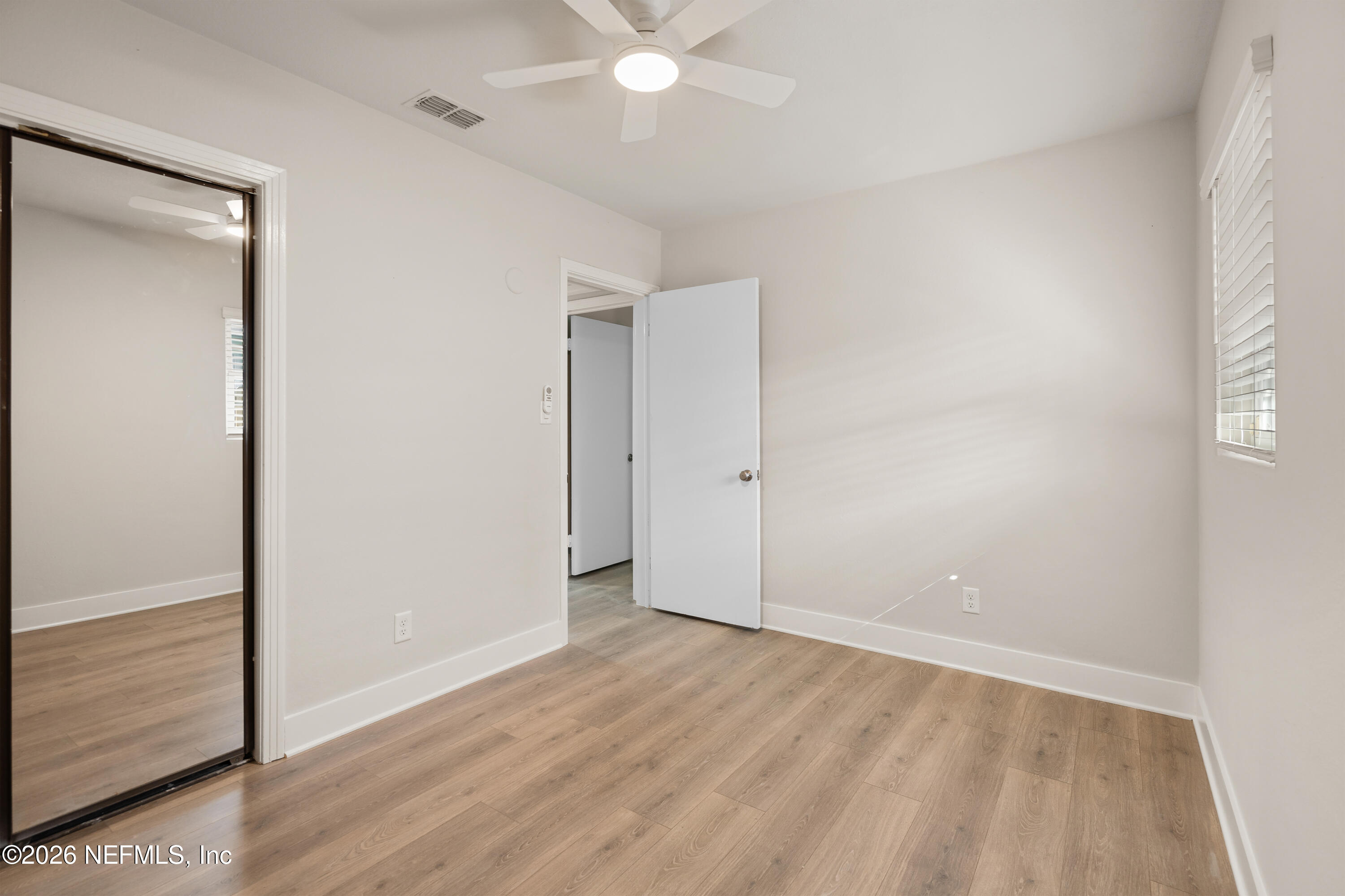 1241 Hibiscus Street St. Augustine, FL 32084 - Photo 20 of 27 an empty room with wooden floor and fan