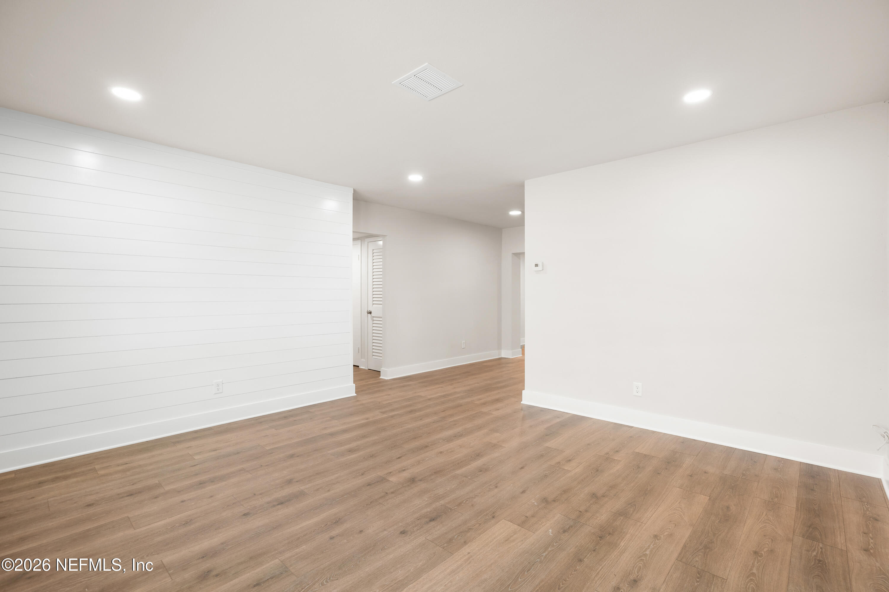 1241 Hibiscus Street St. Augustine, FL 32084 - Photo 6 of 27 an empty room with wooden floor and windows