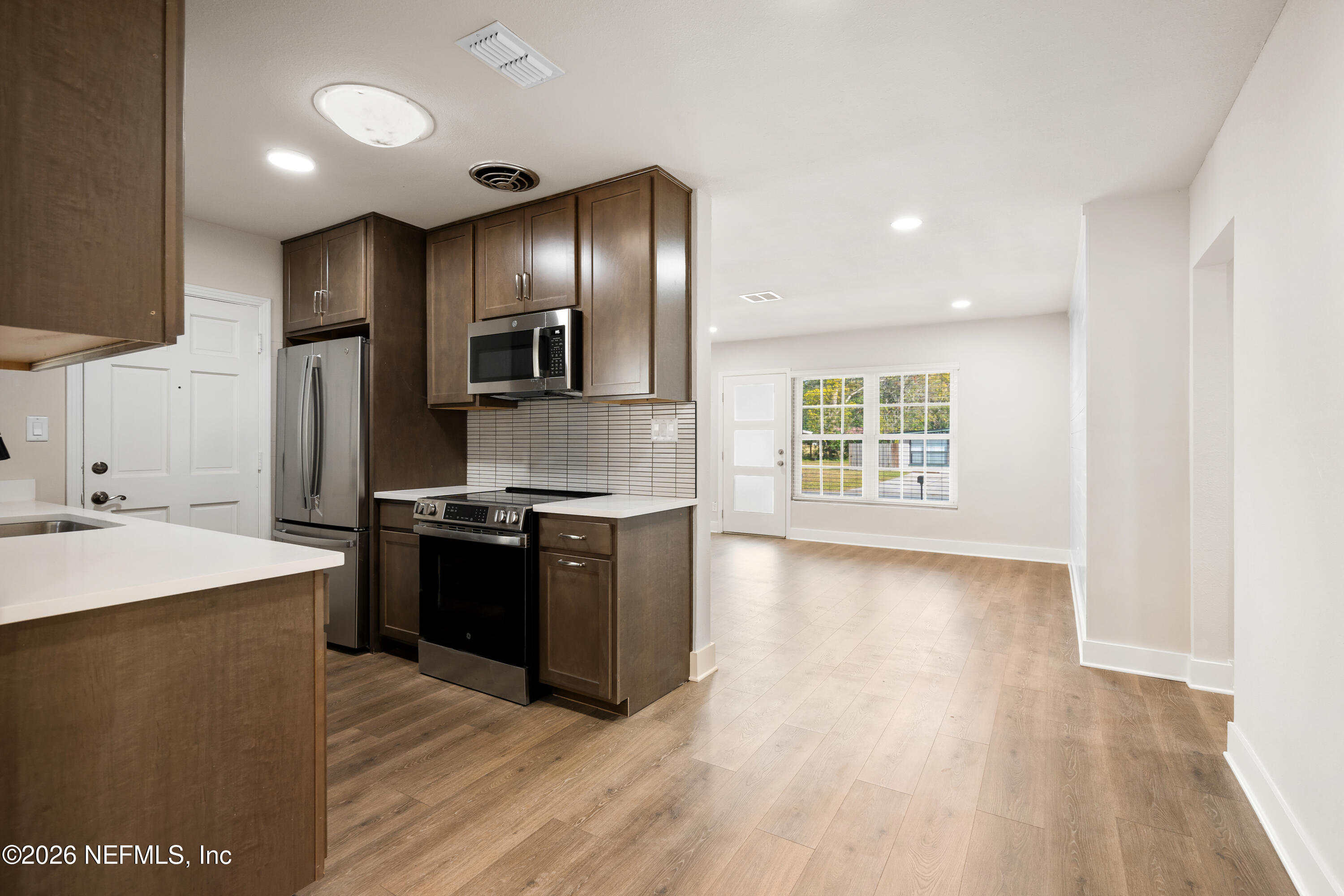 1241 Hibiscus Street St. Augustine, FL 32084 - Photo 9 of 27 a large kitchen with stainless steel appliances granite countertop a stove a sink and a refrigerator