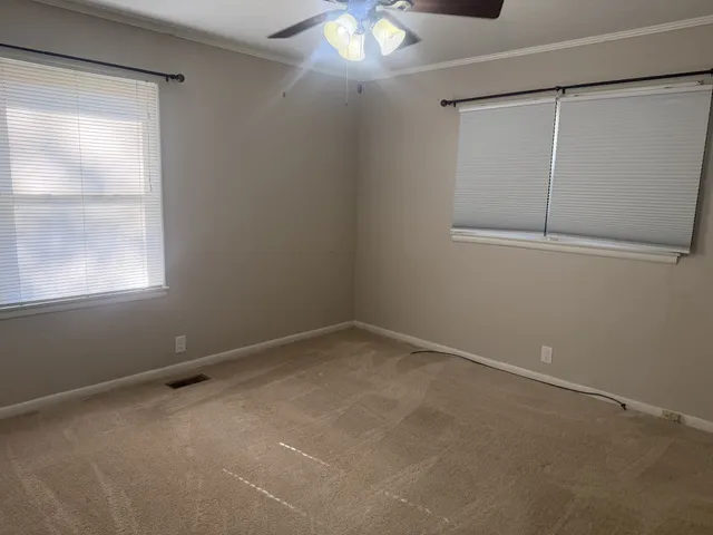 a bathroom with a toilet and a shower curtain