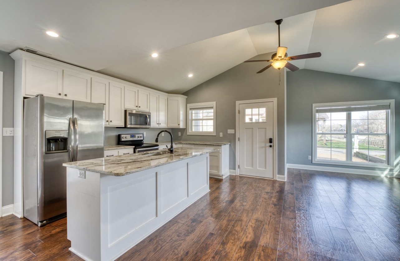 807 Clear Creek Road Pulaski, TN 38478 - Photo 7 of 17 a kitchen with kitchen island granite countertop stainless steel appliances a sink cabinets and wooden floor