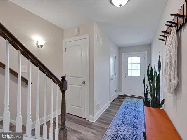 a view of entryway with wooden floor and a livingroom