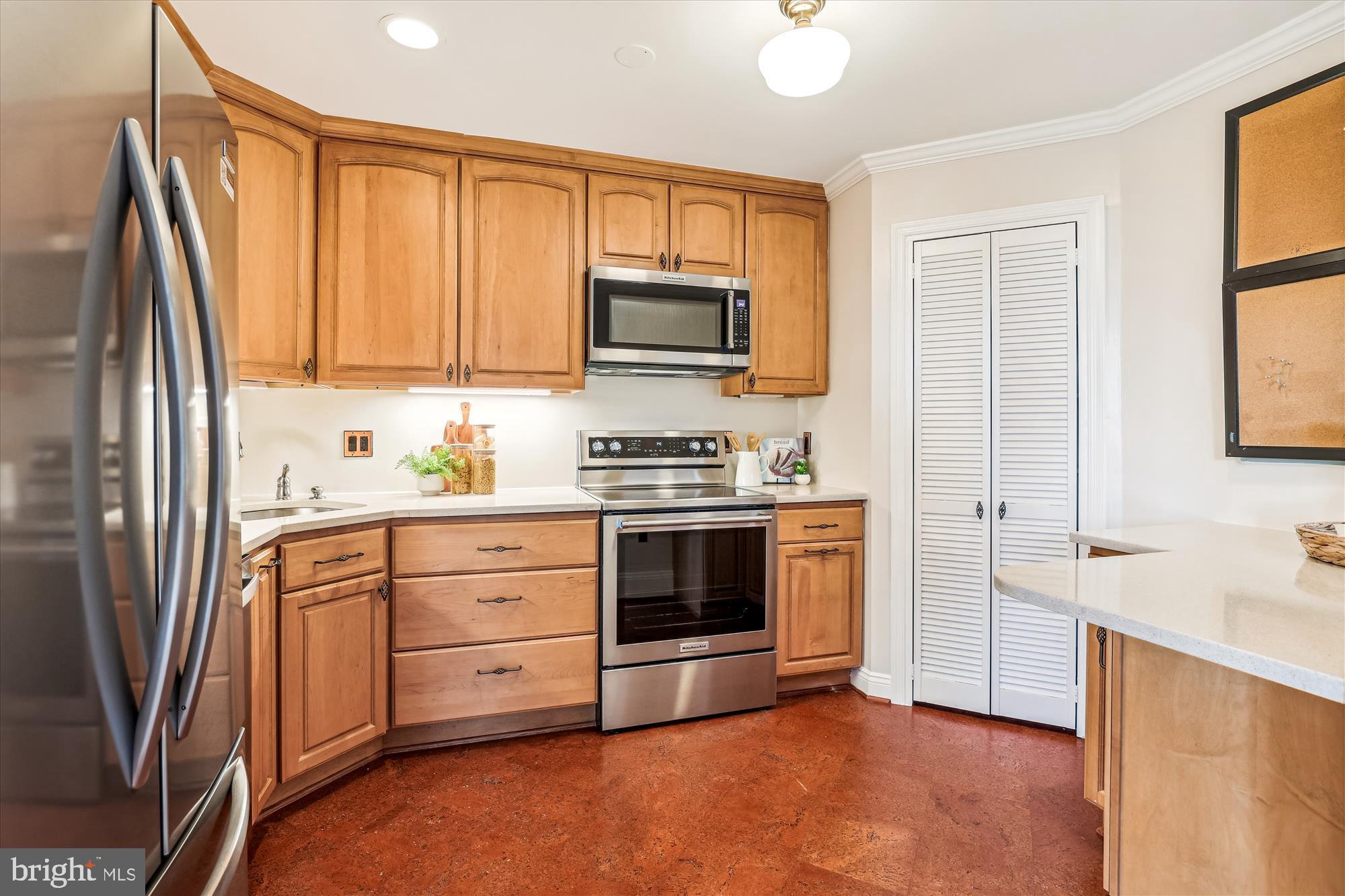 955 26th Street Northwest, Unit 512 Washington, DC 20037 - Photo 12 of 41 a kitchen with stainless steel appliances white cabinets and a stove top oven