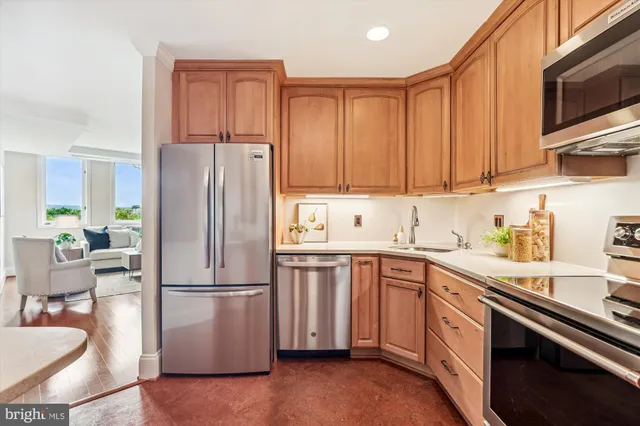 a kitchen with stainless steel appliances granite countertop a refrigerator sink and cabinets