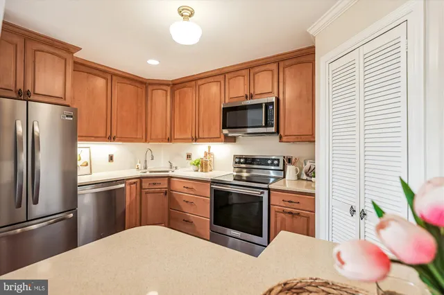 a kitchen with a sink stainless steel appliances and cabinets