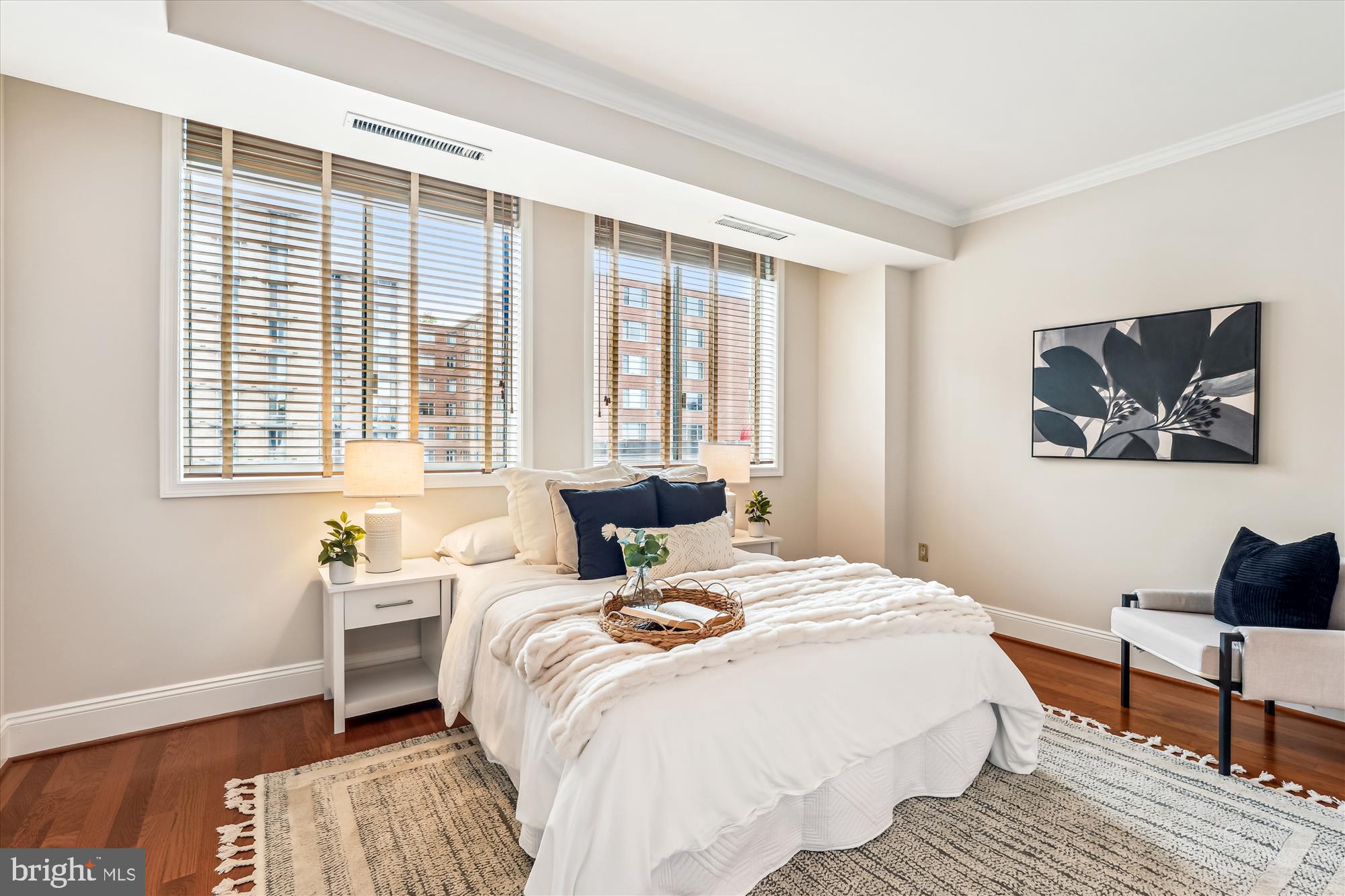 955 26th Street Northwest, Unit 512 Washington, DC 20037 - Photo 15 of 41 a bedroom with a bed and wooden floor