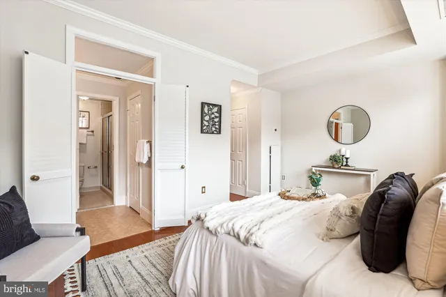 a bedroom with a bed and painting on the wall