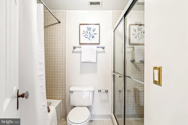 a white toilet sitting next to a bathroom sink