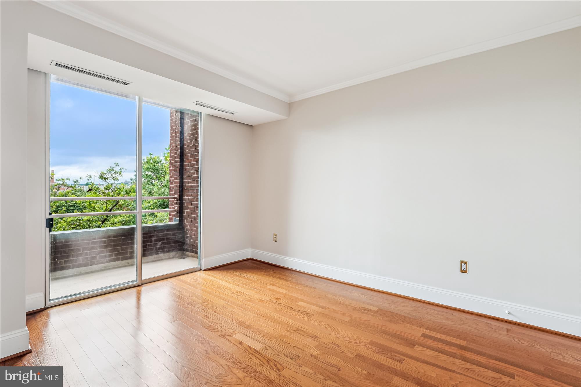 955 26th Street Northwest, Unit 512 Washington, DC 20037 - Photo 26 of 41 an empty room with wooden floor and windows