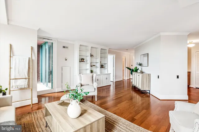 a living room with furniture dining table and wooden floor