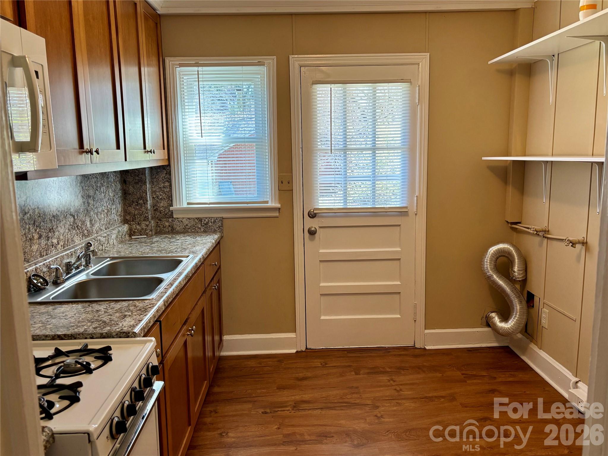 324 East Rhodes Street Lincolnton, NC 28092 - Photo 5 of 10 a kitchen with a sink a stove and cabinets