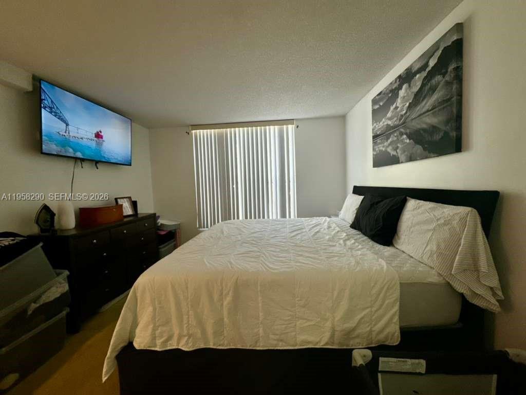 3720 Inverrary Drive, Unit 2S Lauderhill, FL 33319 - Photo 11 of 31 a bed room with a bed and wall painting