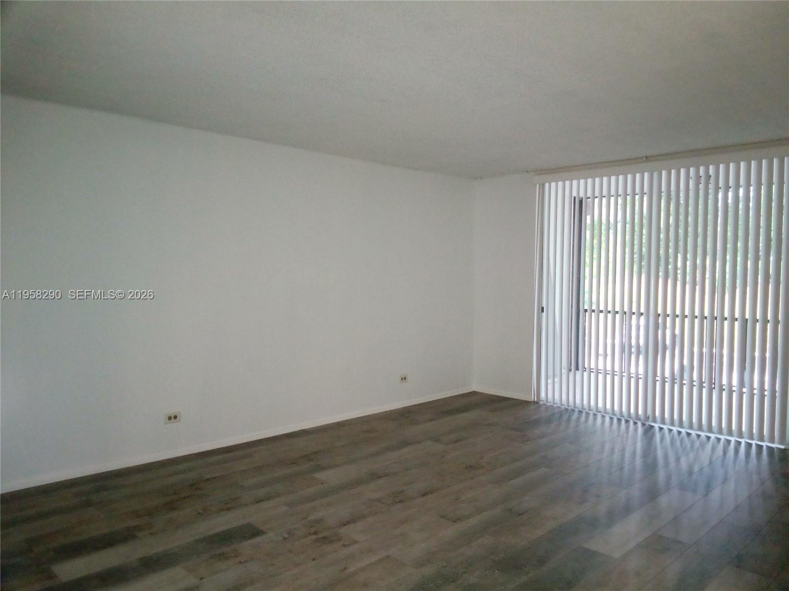 3720 Inverrary Drive, Unit 2S Lauderhill, FL 33319 - Photo 22 of 49 a view of an empty room with wooden floor and a window