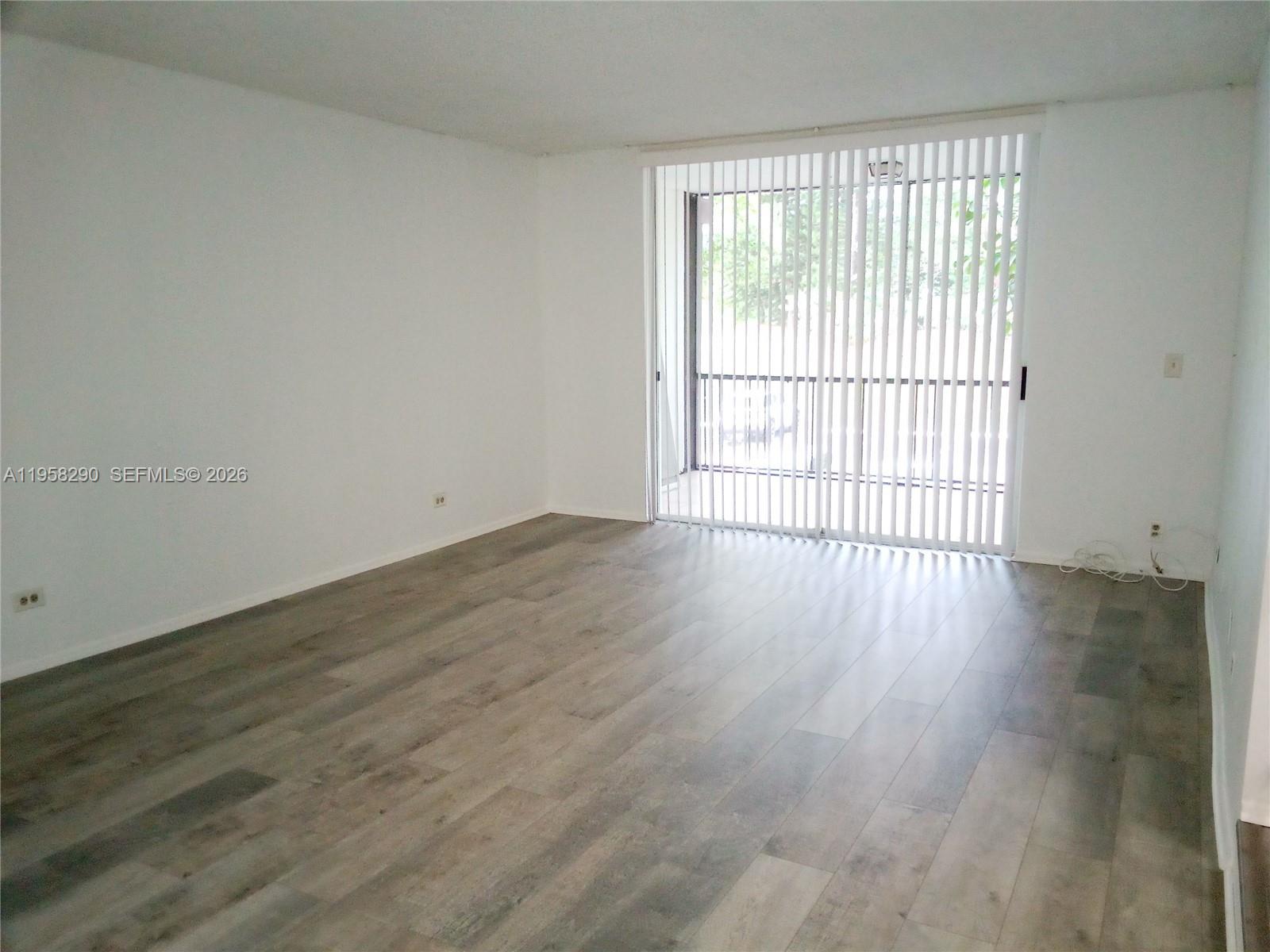 3720 Inverrary Drive, Unit 2S Lauderhill, FL 33319 - Photo 23 of 49 wooden floor in an empty room with a window