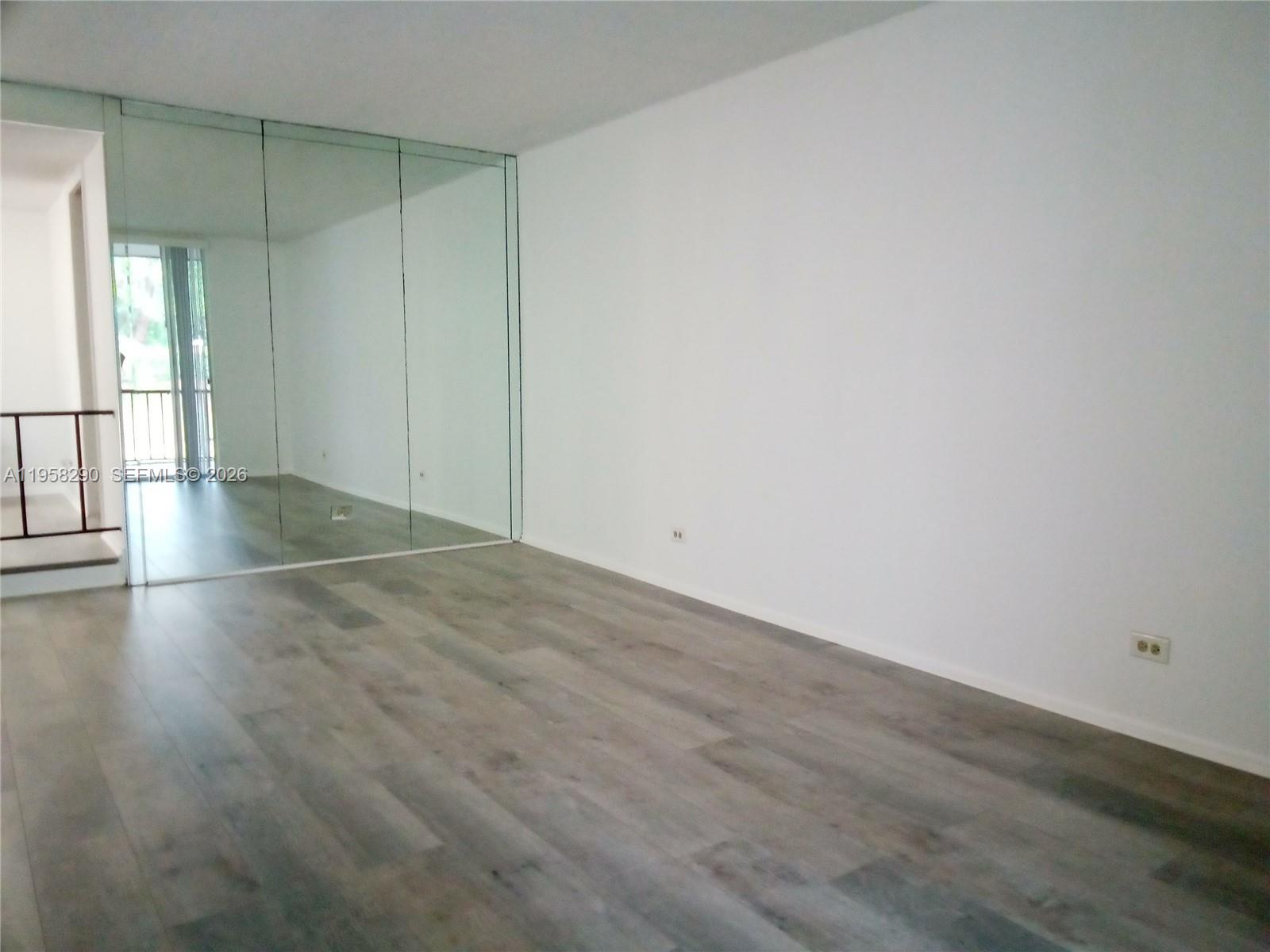 3720 Inverrary Drive, Unit 2S Lauderhill, FL 33319 - Photo 24 of 49 an empty room with wooden floor and windows