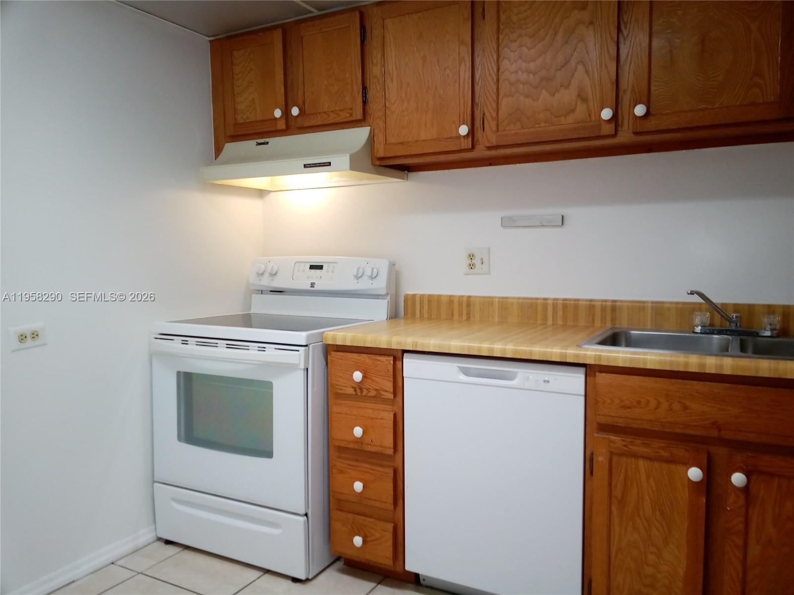 3720 Inverrary Drive, Unit 2S Lauderhill, FL 33319 - Photo 26 of 49 a kitchen with a sink and cabinets
