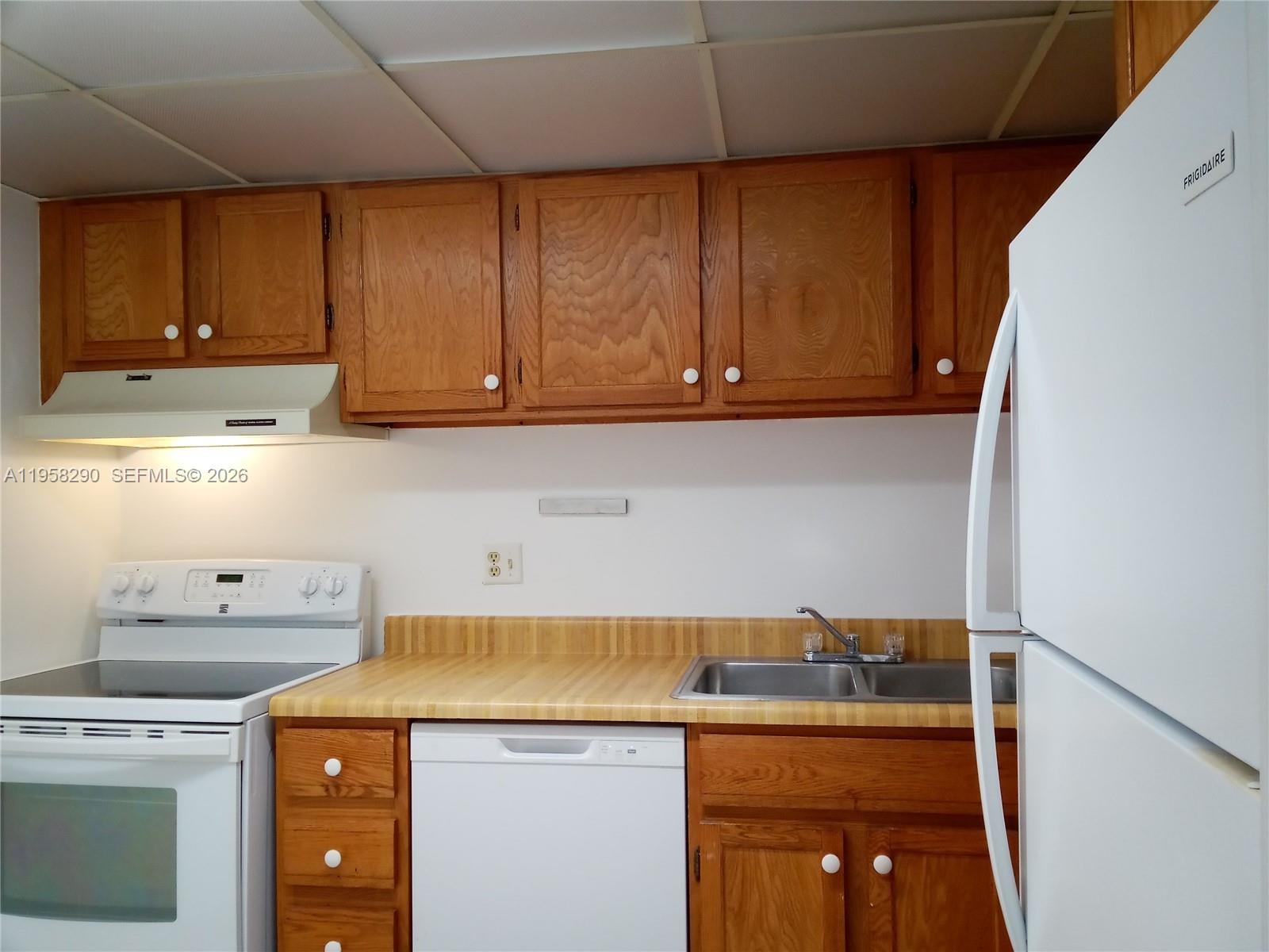 3720 Inverrary Drive, Unit 2S Lauderhill, FL 33319 - Photo 27 of 49 a kitchen with a sink a stove and cabinets