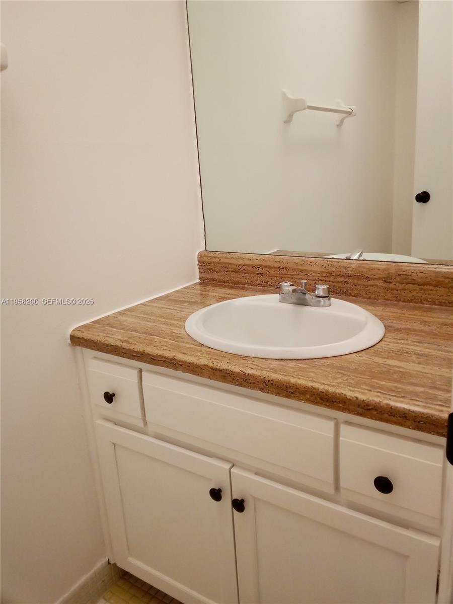 3720 Inverrary Drive, Unit 2S Lauderhill, FL 33319 - Photo 30 of 49 a bathroom with a sink and vanity