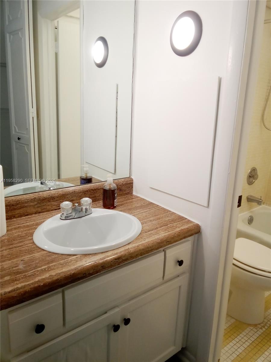 3720 Inverrary Drive, Unit 2S Lauderhill, FL 33319 - Photo 35 of 49 a bathroom with a sink and a mirror