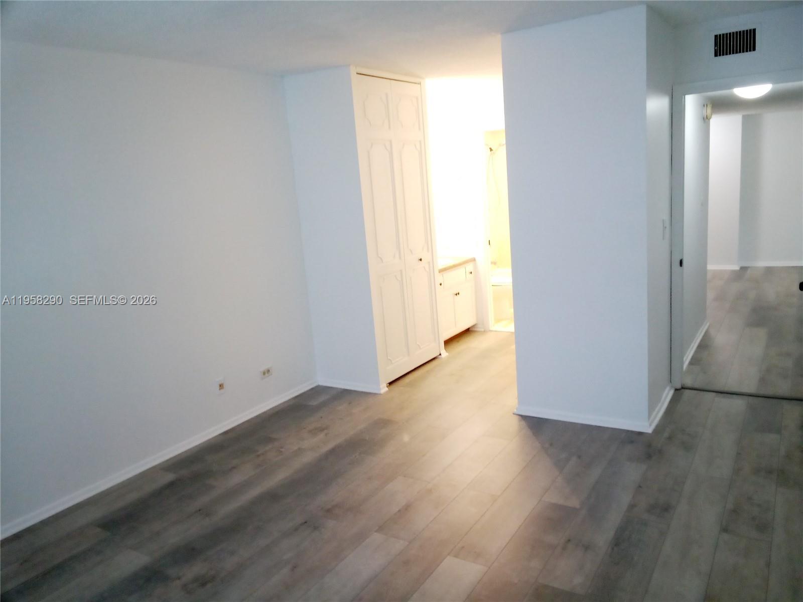 3720 Inverrary Drive, Unit 2S Lauderhill, FL 33319 - Photo 43 of 49 a view of an empty room with wooden floor and a window