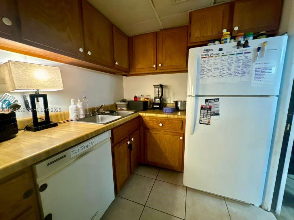 3720 Inverrary Drive, Unit 2S Lauderhill, FL 33319 - Photo 6 of 31 a kitchen with a sink a stove and a refrigerator