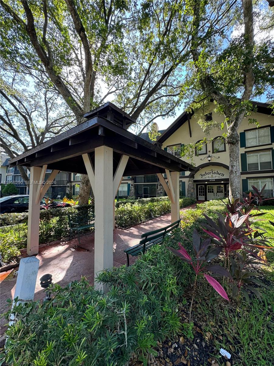 3720 Inverrary Drive, Unit 2S Lauderhill, FL 33319 - Photo 9 of 49 a front view of a house with garden