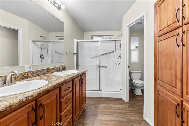 a bathroom with a granite countertop sink toilet and shower