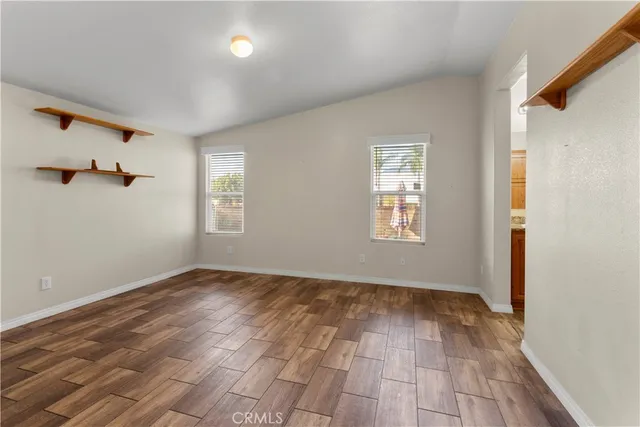 wooden floor in an empty room with a window