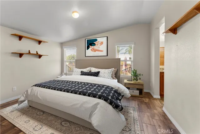 a bedroom with a large bed and a chandelier