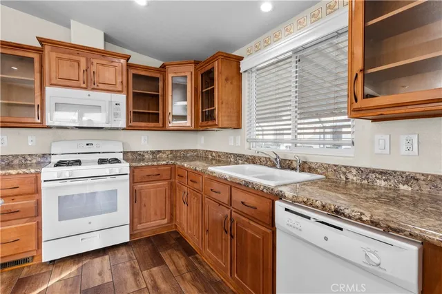 a kitchen with stainless steel appliances granite countertop a stove and a sink