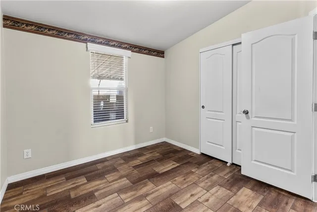a view of a room with wooden floor and closet