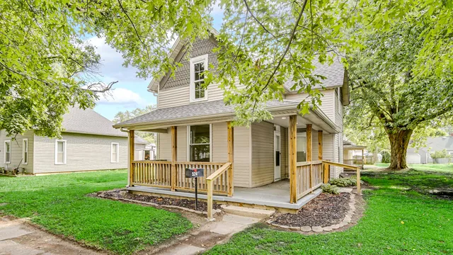 a view of a house with a yard and tree s