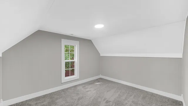 a white house that has a tree in front of it