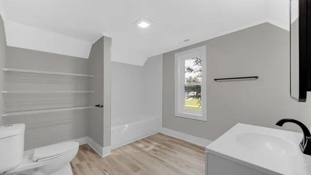 a bathroom with a sink mirror and window