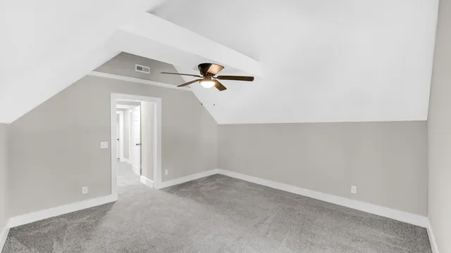 a backyard of a house with large trees and brick walls