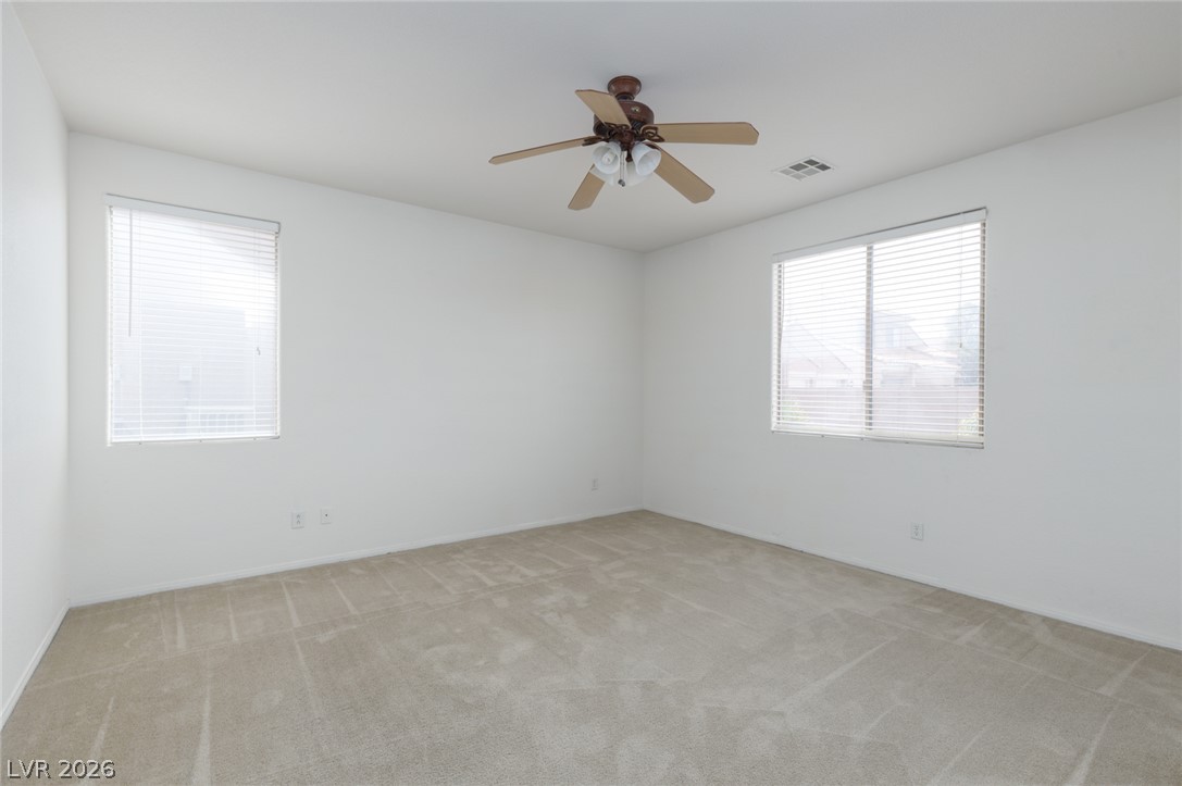 787 Rise Canyon Drive Henderson, NV 89052 - Photo 11 of 22 A pristine bedroom space with carpet flooring, ready for personalization.