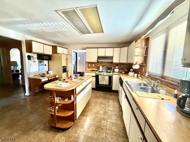 a kitchen with a sink stove and cabinets