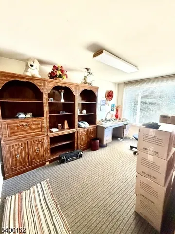 a bedroom with furniture and a large window