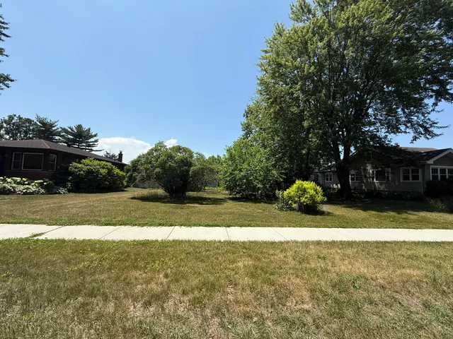a view of yard with swimming pool and green space