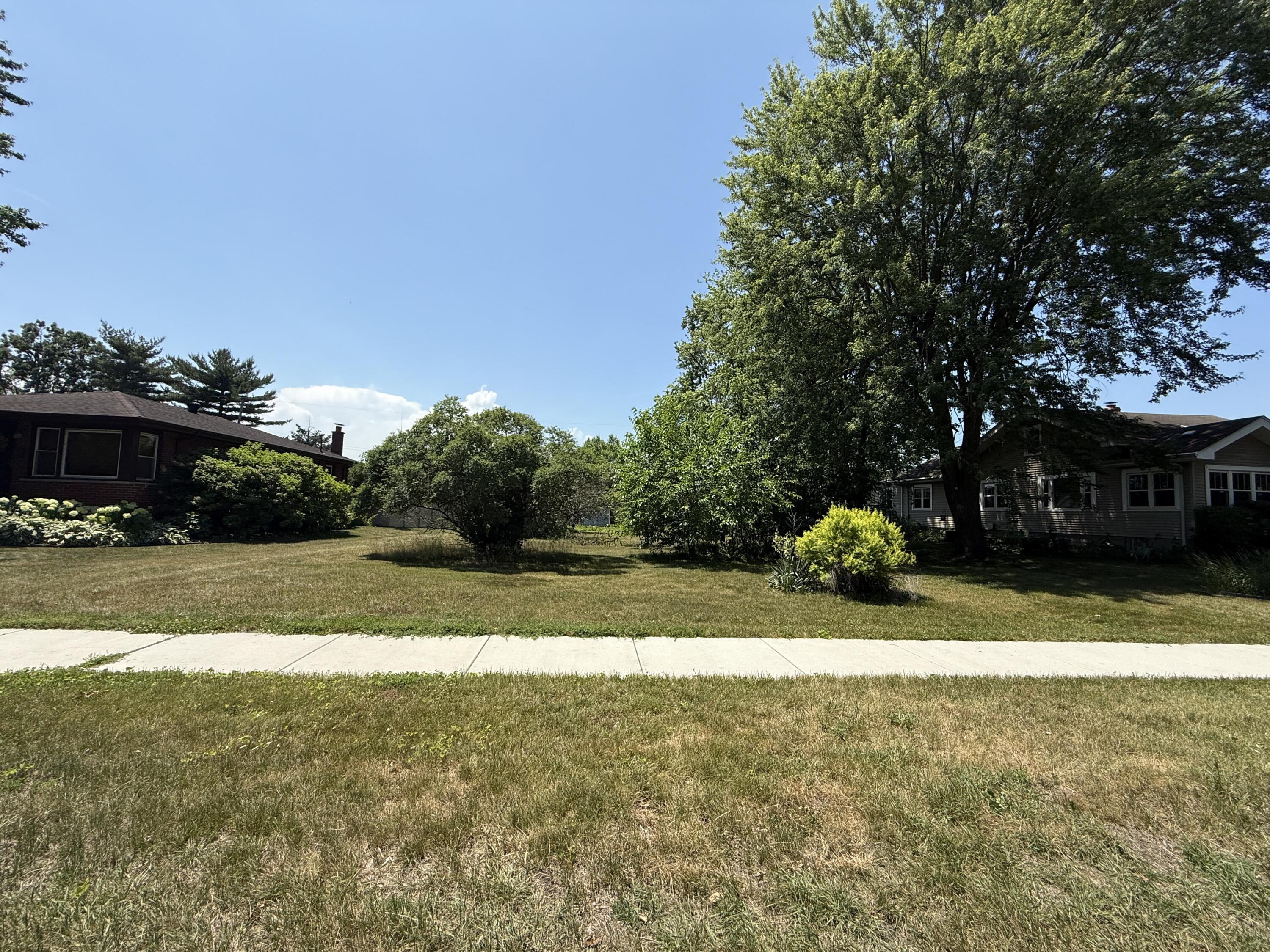 a view of yard with swimming pool and green space