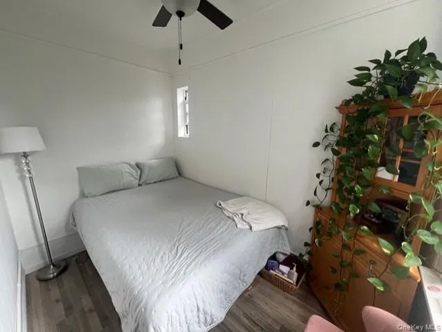 a bedroom with a bed window and a chandelier