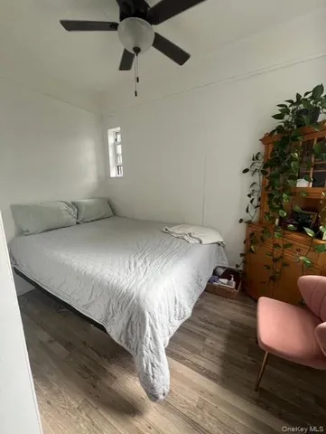 a large bed sitting in a bedroom next to a window and a chair