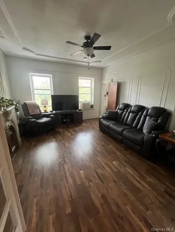 a living room with furniture window and wooden floor