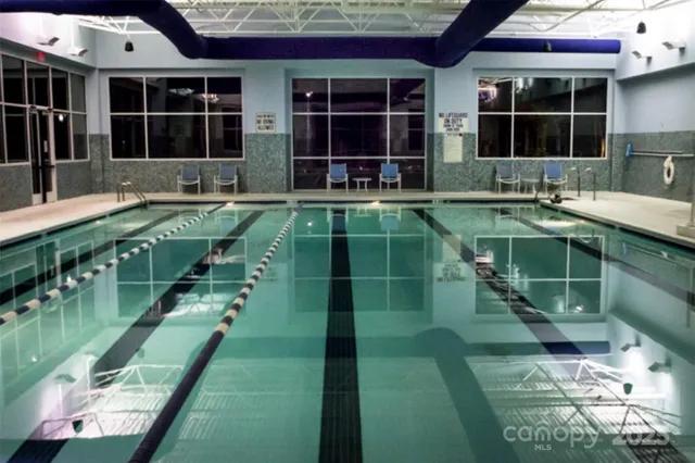 a view of a house with wooden fence next to a road