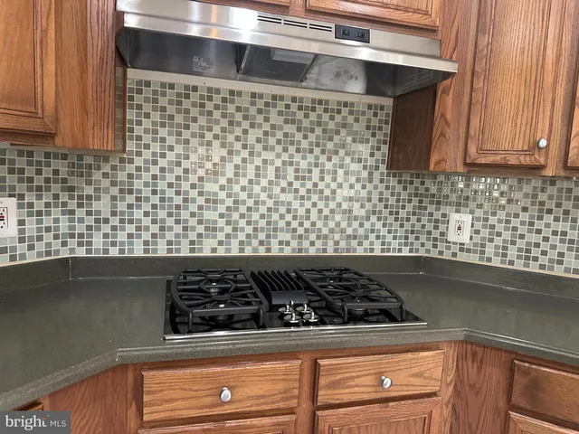 a close view of a stove a microwave and cabinets in the kitchen